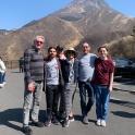 a group of people posing for a picture in front of a mountain