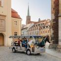 a group of people riding a golf cart down a street