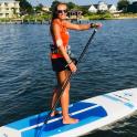 a woman standing on a paddle board in the water