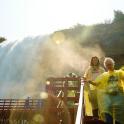 two women standing in front of a waterfall