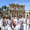 a group of people posing in front of the coliseum