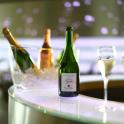 a bottle of champagne and two glasses of wine