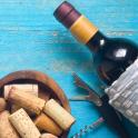a bottle of wine and a bowl of wine corks