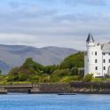 a boat in the water in front of a castle