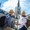 two people wearing hats standing in front of a building