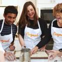 a group of people in a kitchen preparing food