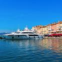 a large white boat in the water next to buildings