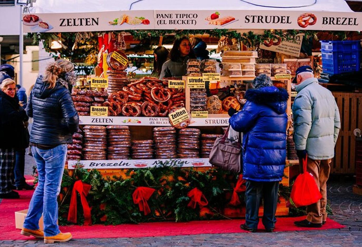 a group of people standing in front of a food stand