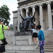a group of people standing in front of a statue