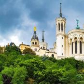 a large building with two towers on top of trees