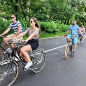 a group of people riding bikes down a road