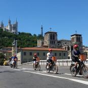 a group of people riding bikes down a road