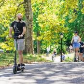 a man riding a scooter in a park