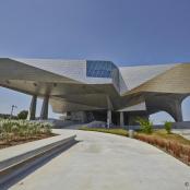 a building with a geometric roof with a pathway