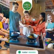 a group of people standing in a kitchen preparing food