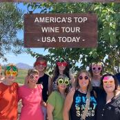 a group of people wearing face masks standing in front of a sign