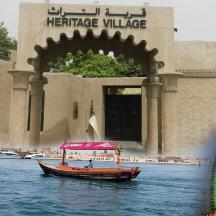 a small boat in the water in front of a building