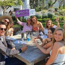 a group of people sitting around a wooden table
