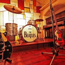 a room filled with guitars and a drum set
