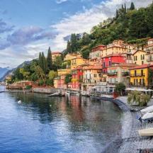a town on the side of a river with buildings