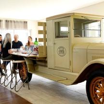 a group of people standing around an old truck