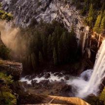 a waterfall in the middle of a mountain