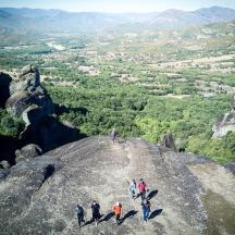 a group of people standing on top of a rock