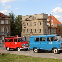 two trucks parked in a parking lot in front of a building