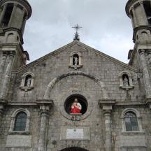 an old church with a woman in a window