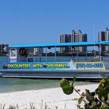 a boat on the water next to a beach