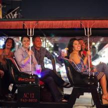 a group of people riding on a trolley