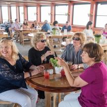 a group of women sitting at a table in a restaurant