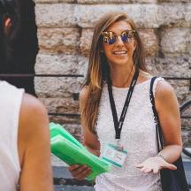 a woman wearing sunglasses holding a green frisbee