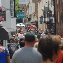a crowd of people walking down a busy city street
