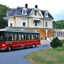 a trolley bus parked in front of a house