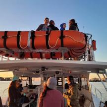 a group of people on the top of a boat