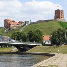 a bridge over a river with a castle on a hill