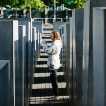 a woman standing on stairs looking at her cell phone
