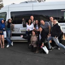 a group of people standing in front of a van