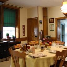 a kitchen with a table with chairs and a dining room