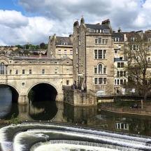 a bridge over a river in front of a building