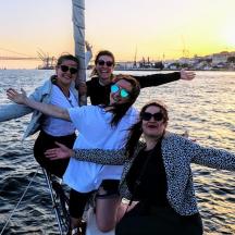 four people on a sail boat in the water