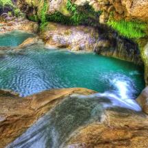 un estanque de agua en una cueva con rocas