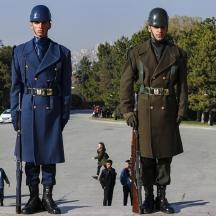 two men standing next to each other in a parking lot