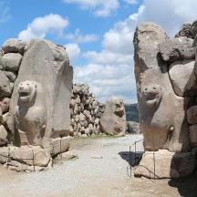 a rock wall with two statues of faces on it