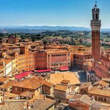 an aerial view of a city with a clock tower