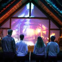 a group of people standing in front of a fire