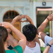a group of people making a heart with their hands