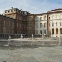 a large building with water fountains in front of it