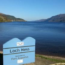 a sign in front of a large body of water